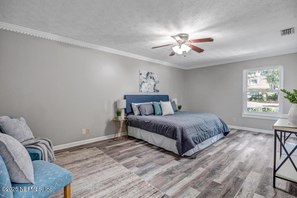 4448 Charter Point Boulevard Jacksonville, FL 32277 - Photo 27 of 47 a spacious bedroom with a bed and window