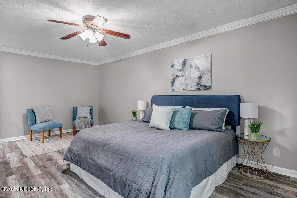 4448 Charter Point Boulevard Jacksonville, FL 32277 - Photo 28 of 47 a bedroom with bed and a chandelier