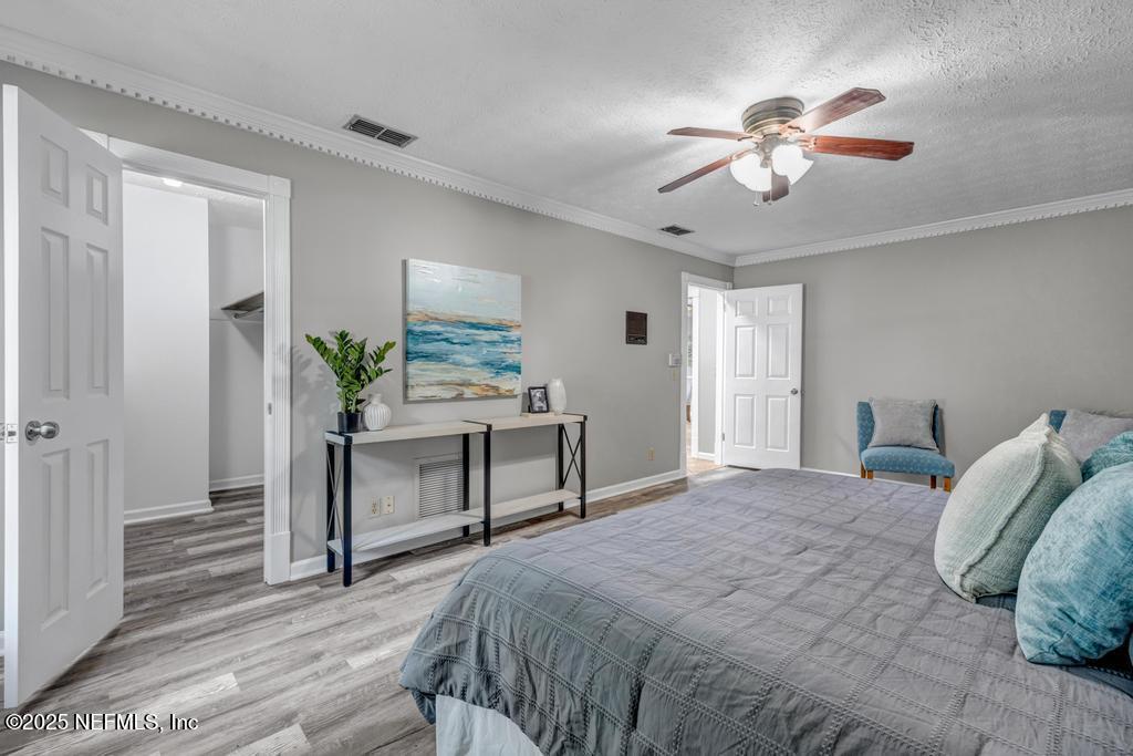 4448 Charter Point Boulevard Jacksonville, FL 32277 - Photo 29 of 47 a bedroom with a bed and a chandelier