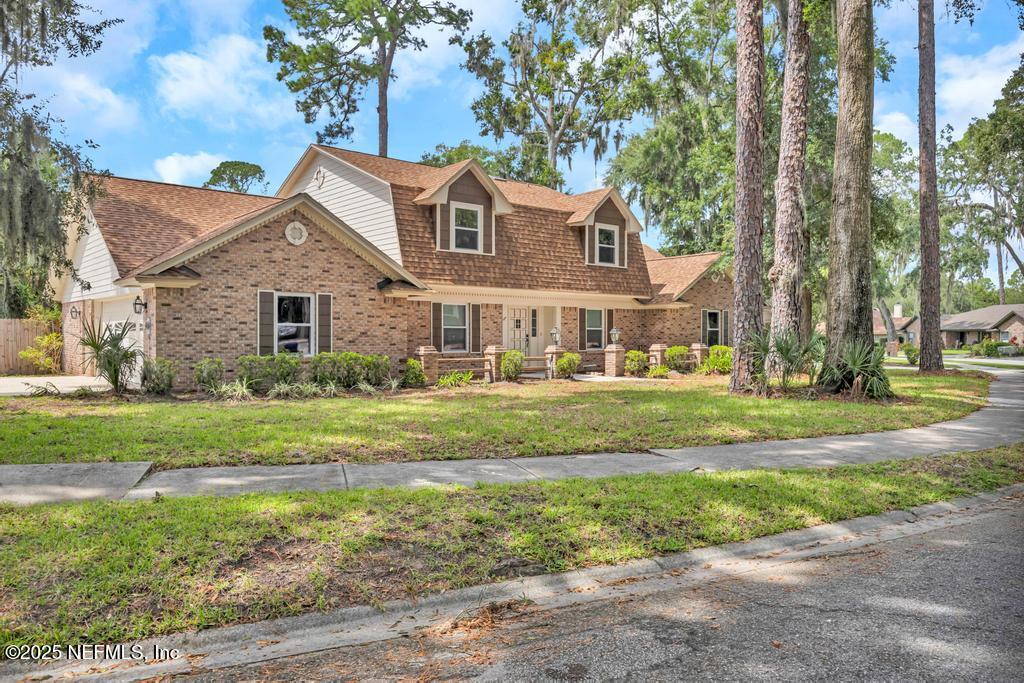 4448 Charter Point Boulevard Jacksonville, FL 32277 - Photo 3 of 47 a front view of a house with a yard
