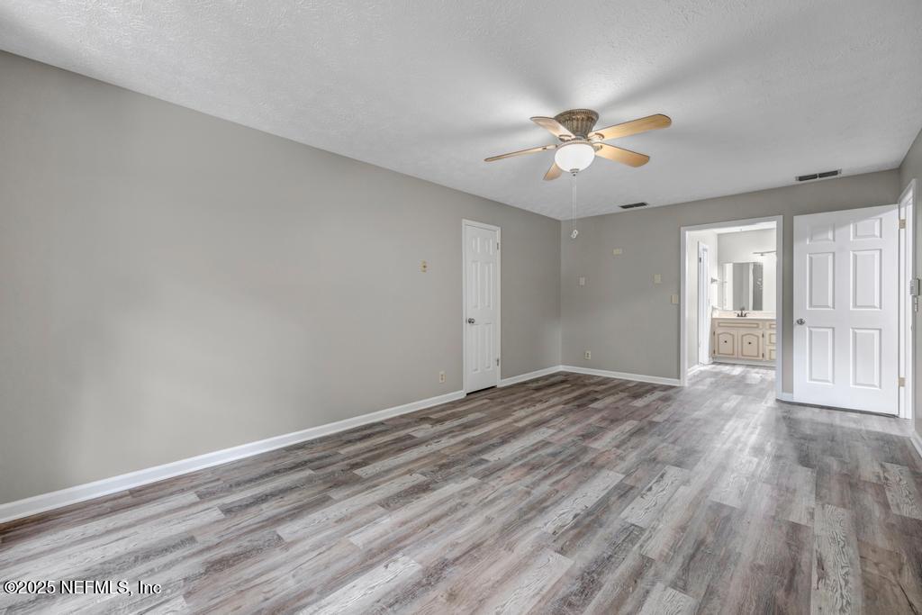4448 Charter Point Boulevard Jacksonville, FL 32277 - Photo 34 of 47 a view of empty room with wooden floor and fan
