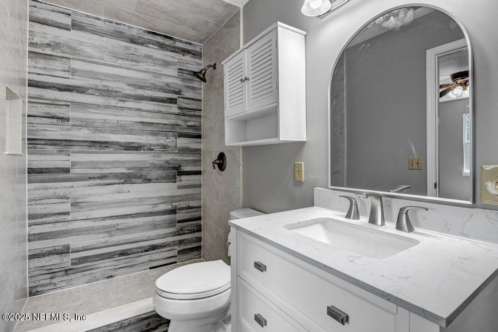 4448 Charter Point Boulevard Jacksonville, FL 32277 - Photo 38 of 47 a bathroom with a granite countertop sink toilet and shower