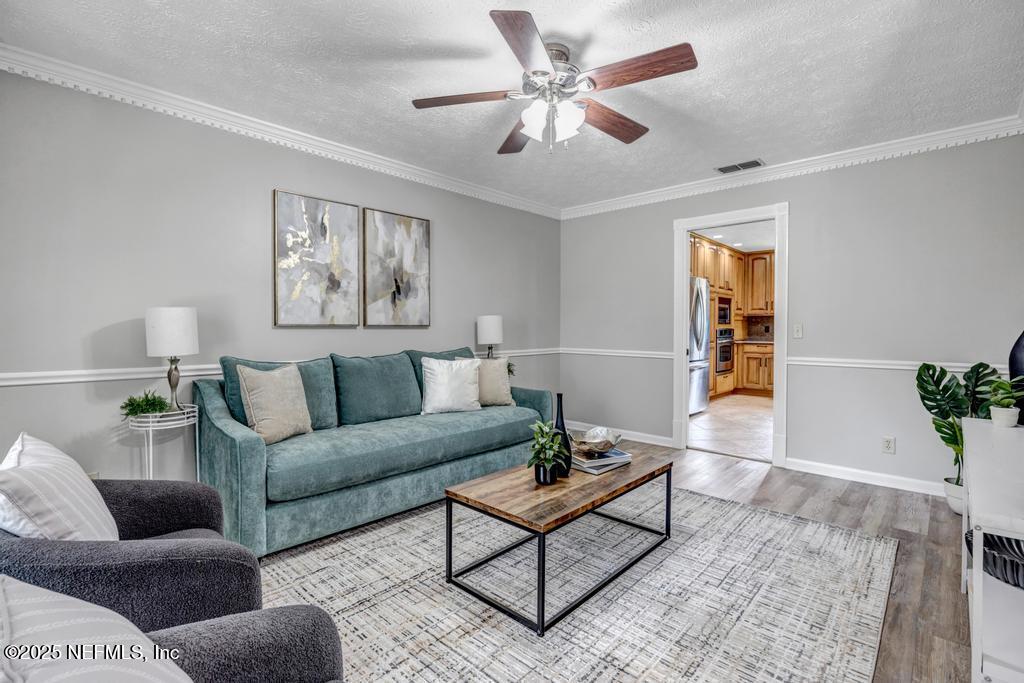 4448 Charter Point Boulevard Jacksonville, FL 32277 - Photo 8 of 47 a living room with furniture and a potted plant