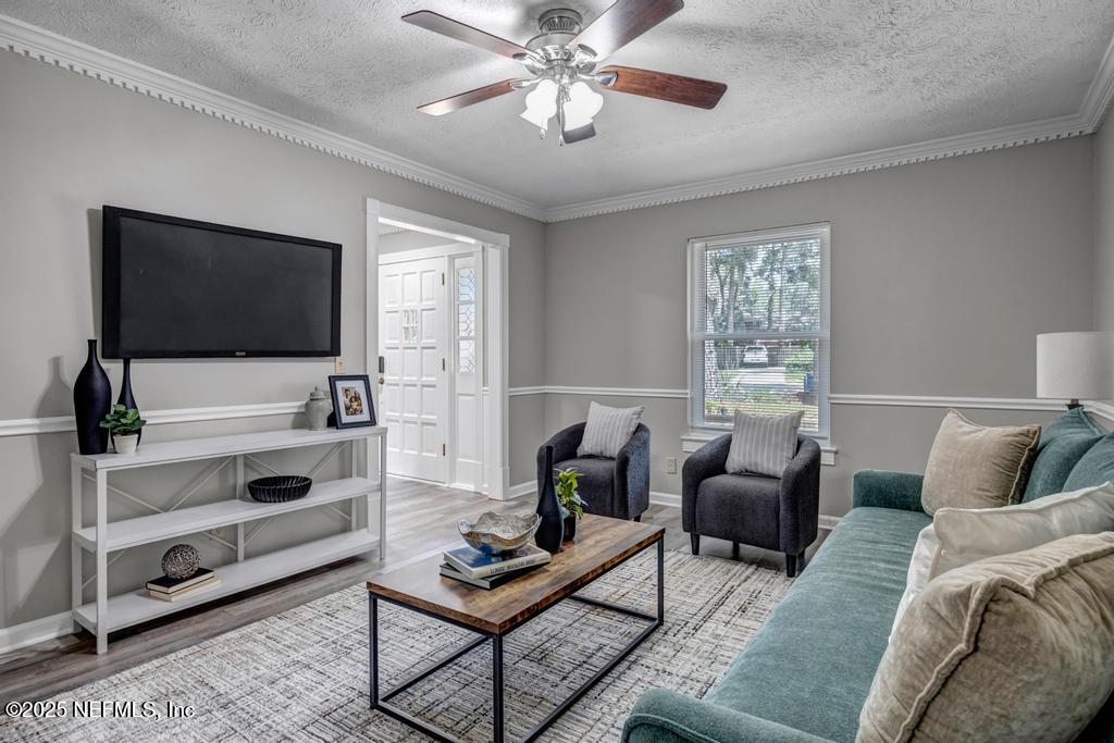 4448 Charter Point Boulevard Jacksonville, FL 32277 - Photo 9 of 47 a living room with furniture and a flat screen tv