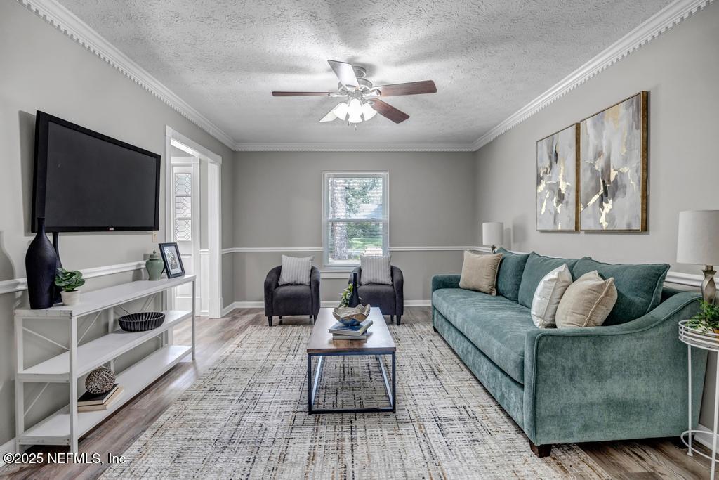 4448 Charter Point Boulevard Jacksonville, FL 32277 - Photo 10 of 47 a living room with furniture and a flat screen tv