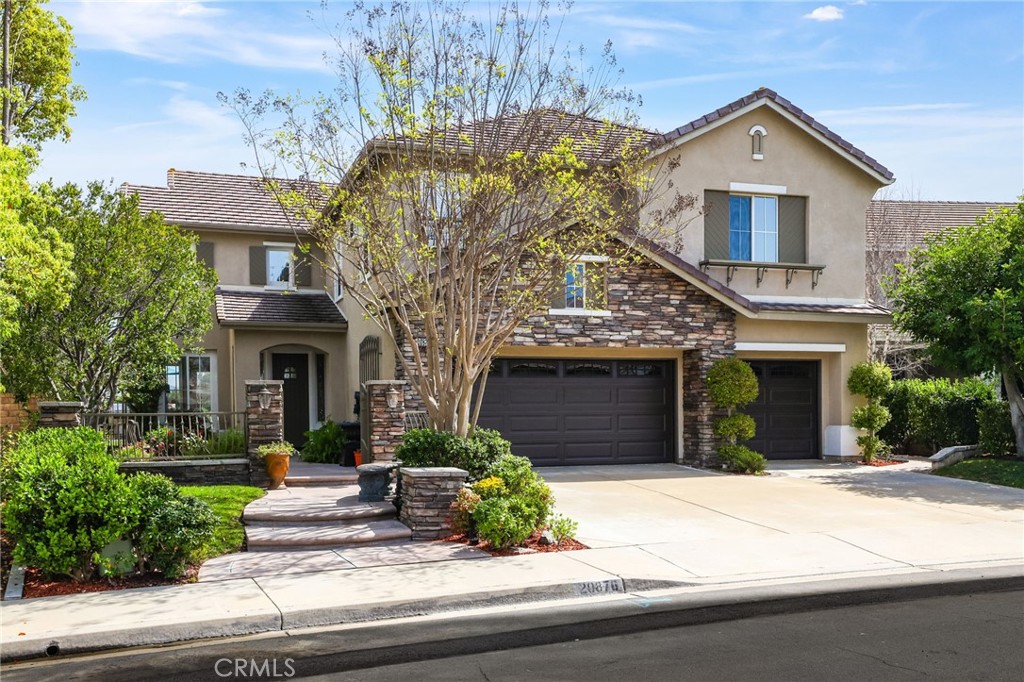 20876 Parkside Lake Forest, CA 92630 - Photo 1 of 1 a front view of a house with a garden and plants