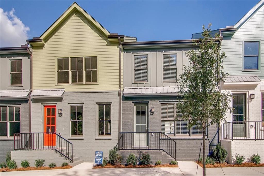 a view of a white house with large windows