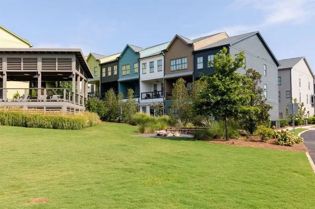 a front view of a house with a yard and potted plants