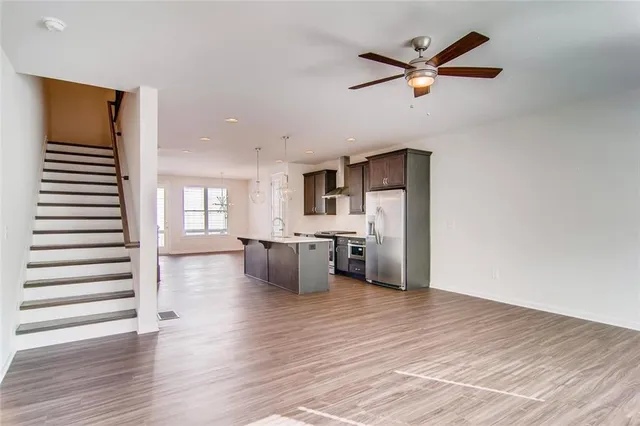 a view of a livingroom with a kitchen and wooden floor
