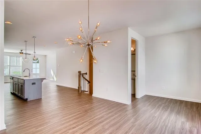 a view of an empty room and window with wooden floor