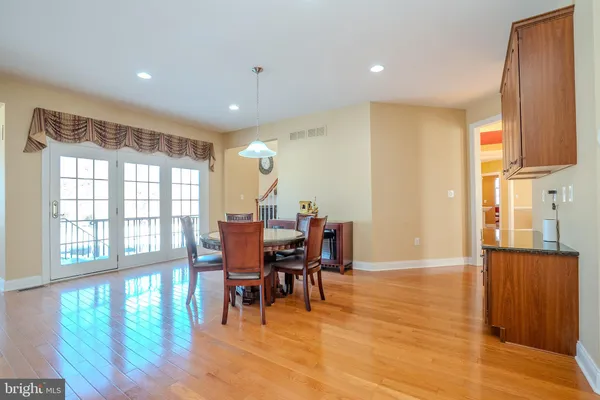 a view of a dining room with furniture and a chandelier