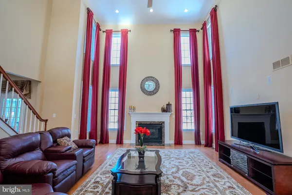a view of staircase with lots of frames on wall and a large window