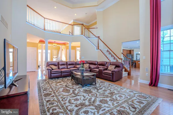 a view of staircase with lots of frames on wall and a rug