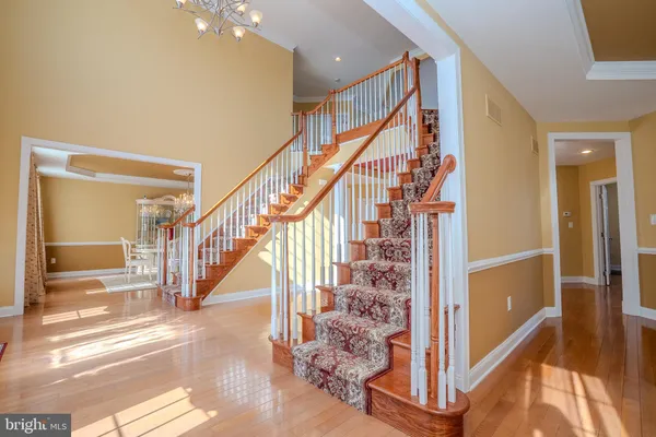 a spacious bathroom with a tub sink and a mirror