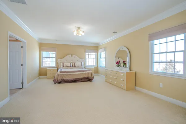 a spacious bathroom with a granite countertop sink and a mirror