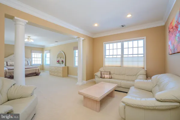 a view of a livingroom with wooden floor and a flat screen tv