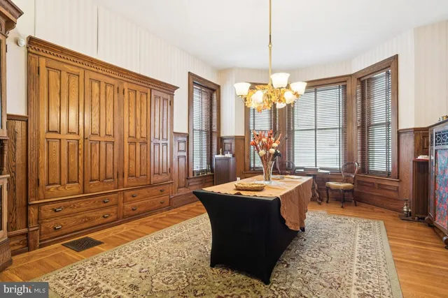 a dining room with granite countertop furniture and a chandelier