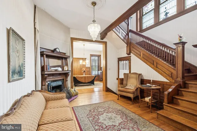 a living room with furniture fireplace and a rug
