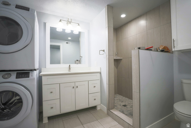422 West Buckeye Reef Road Leeds, UT 84746 - Photo 31 of 47 Full bath with vanity, walk in shower, recessed lighting, light tile patterned flooring, and stacked washing machine and dryer