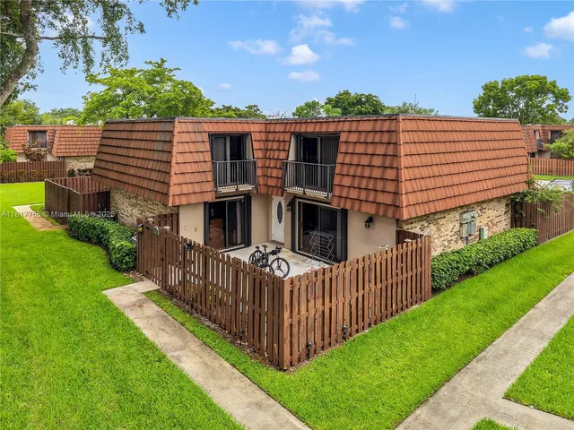 a front view of a house with backyard and deck