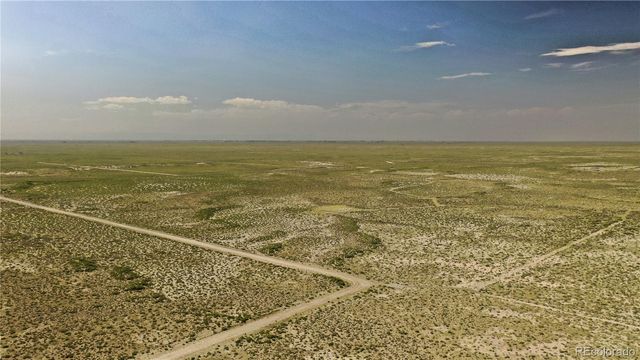 a view of a large mountain with mountains in the background