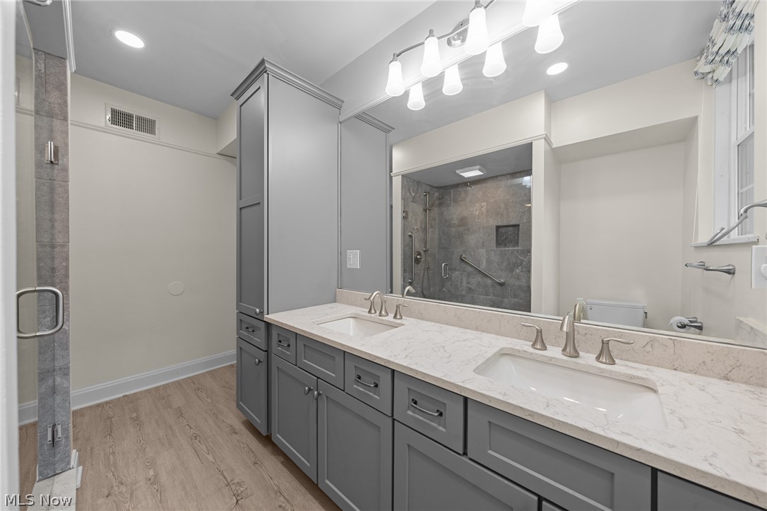 12546 Cedar Road, Unit 4 Cleveland Heights, OH 44106 - Photo 9 of 43 Updated Jack-n Jill full bathroom with double vanity, quartz countertop, and oversized shower