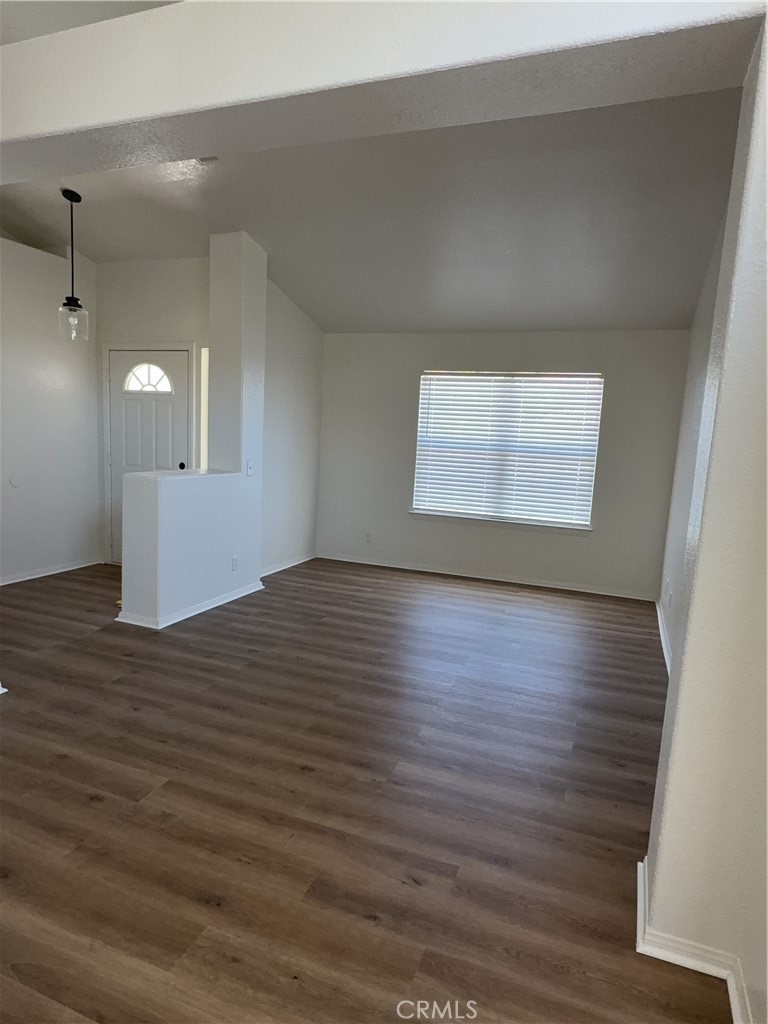 12590 Cobalt Road Victorville, CA 92392 - Photo 10 of 37 an empty room with wooden floor and windows