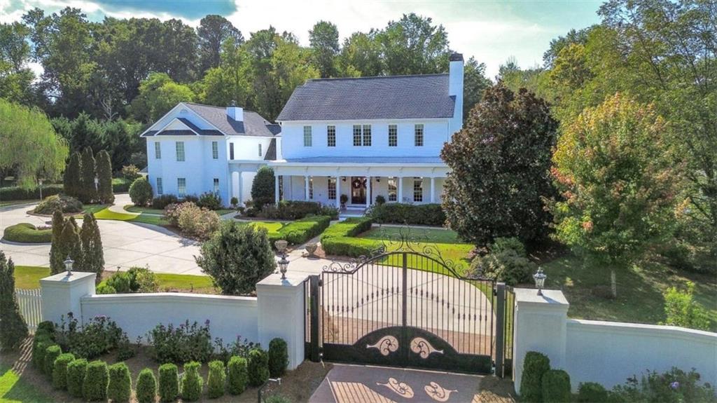132 Holsenbeck School Road Winder, GA 30680 - Photo 1 of 1 an aerial view of a house with swimming pool and large trees