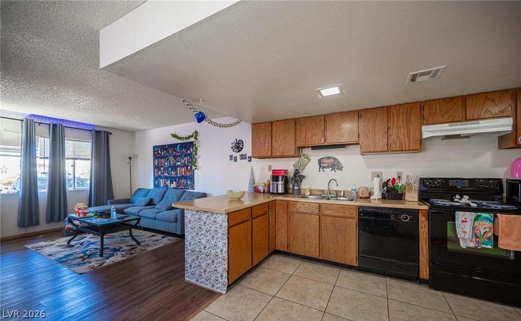 855 Del Rey Drive Boulder City, NV 89005 - Photo 5 of 12 An open-concept living space integrates a well-appointed kitchen with warm wooden cabinetry and functional appliances.