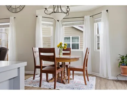 a view of a dining room with furniture and window