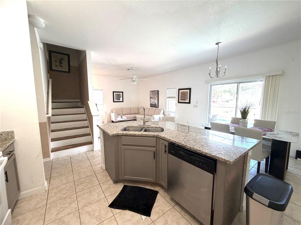4573 Ada Lane Kissimmee, FL 34746 - Photo 7 of 37 a kitchen with a sink and chairs