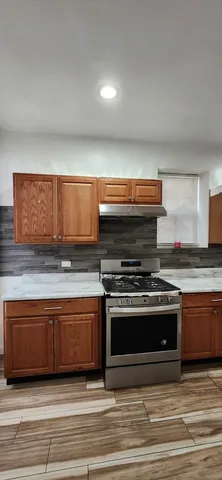 a kitchen with stainless steel appliances granite countertop a stove and a sink