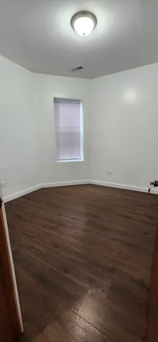 an empty room with wooden floor