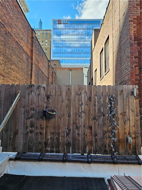 312 Forbes Avenue, Unit 2 Pittsburgh, PA 15222 - Photo 13 of 15 a view of a house with a wooden fence