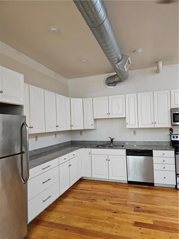 312 Forbes Avenue, Unit 2 Pittsburgh, PA 15222 - Photo 7 of 15 a kitchen with granite countertop a sink stainless steel appliances and cabinets