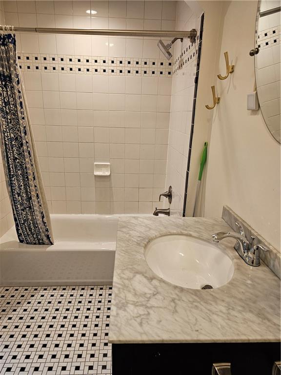 312 Forbes Avenue, Unit 2 Pittsburgh, PA 15222 - Photo 10 of 15 a bathroom with a granite countertop sink and a mirror
