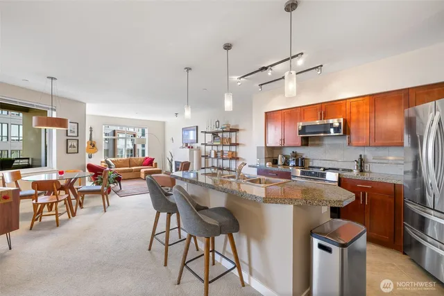 a kitchen with kitchen island a large counter top space appliances and cabinets