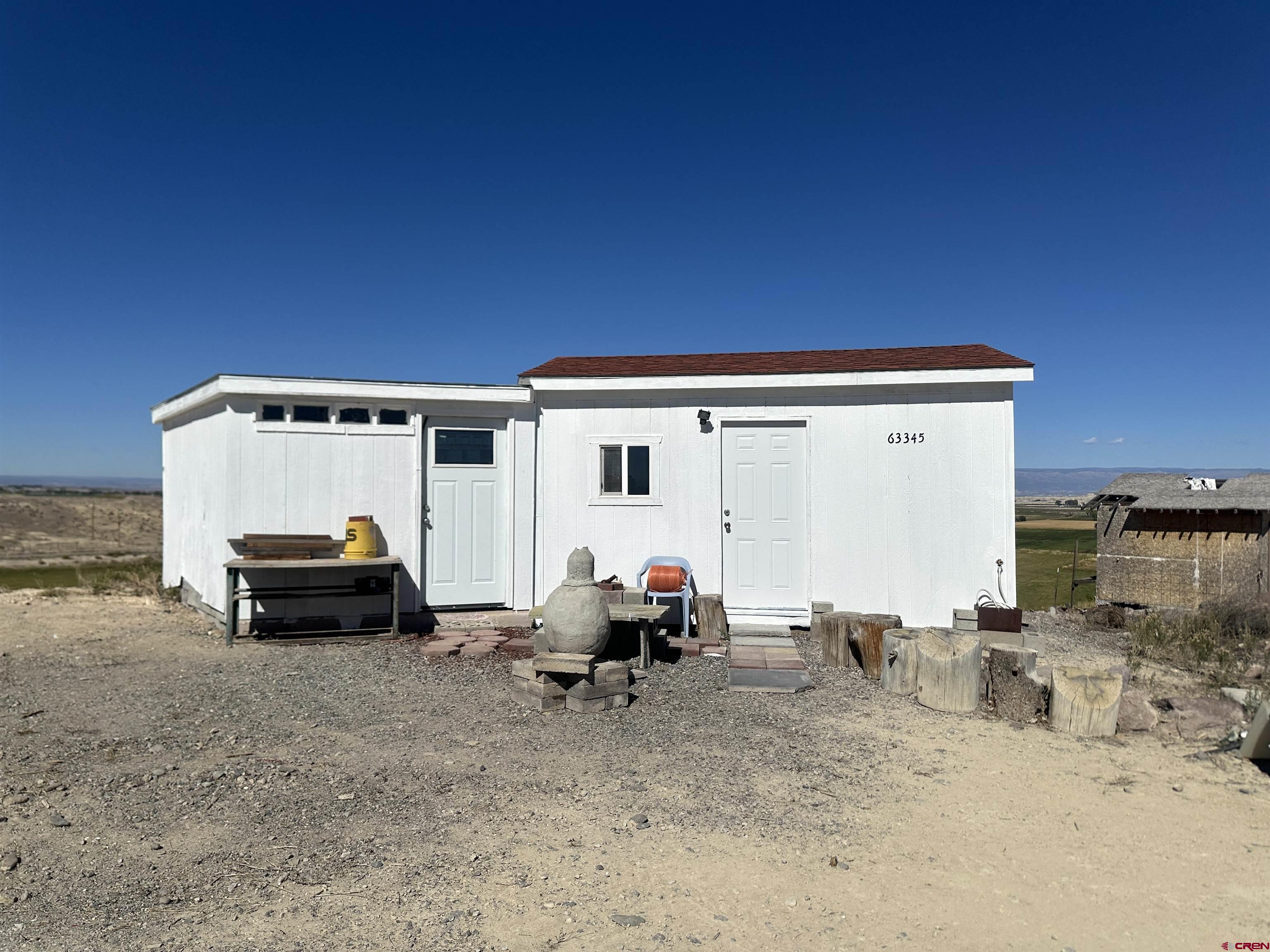 63345 Ida Road Montrose, CO 81401 - Photo 11 of 22 a car parked in front of a white house