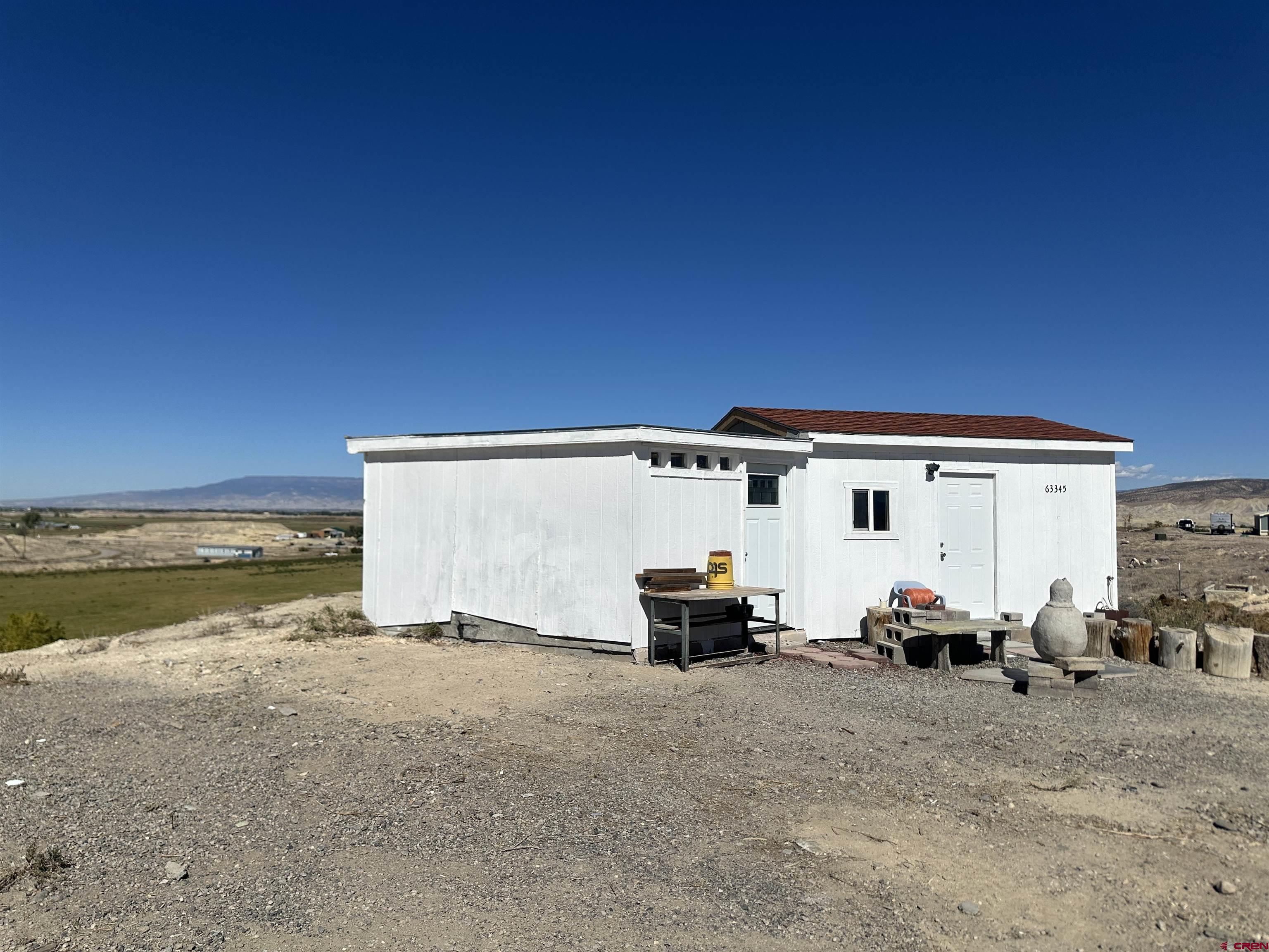 63345 Ida Road Montrose, CO 81401 - Photo 12 of 22 a view of car parked in front of house