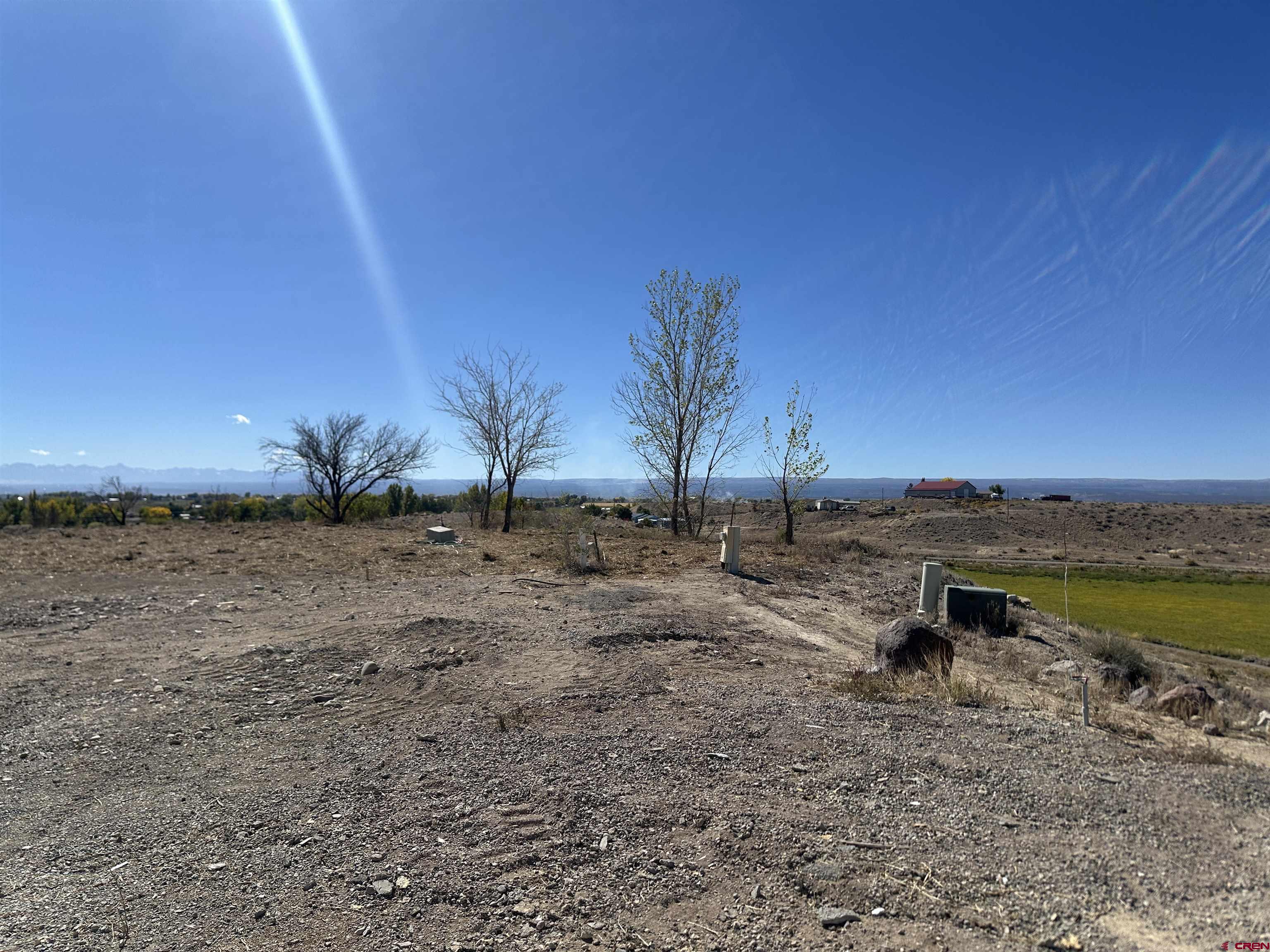 63345 Ida Road Montrose, CO 81401 - Photo 4 of 22 a view of a lake with a big yard
