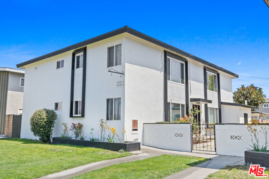 10024 Foster Road Bellflower, CA 90706 - Photo 1 of 29 a front view of a house with a yard