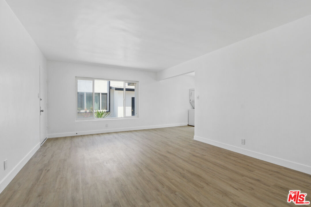 10024 Foster Road Bellflower, CA 90706 - Photo 15 of 29 wooden floor in an empty room with a window