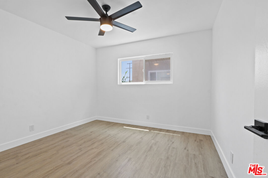 10024 Foster Road Bellflower, CA 90706 - Photo 17 of 29 an empty room with wooden floor and windows