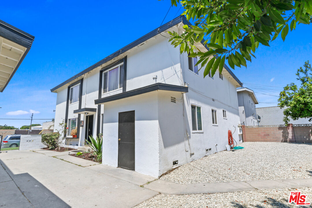 10024 Foster Road Bellflower, CA 90706 - Photo 5 of 29 a front view of a house with a yard