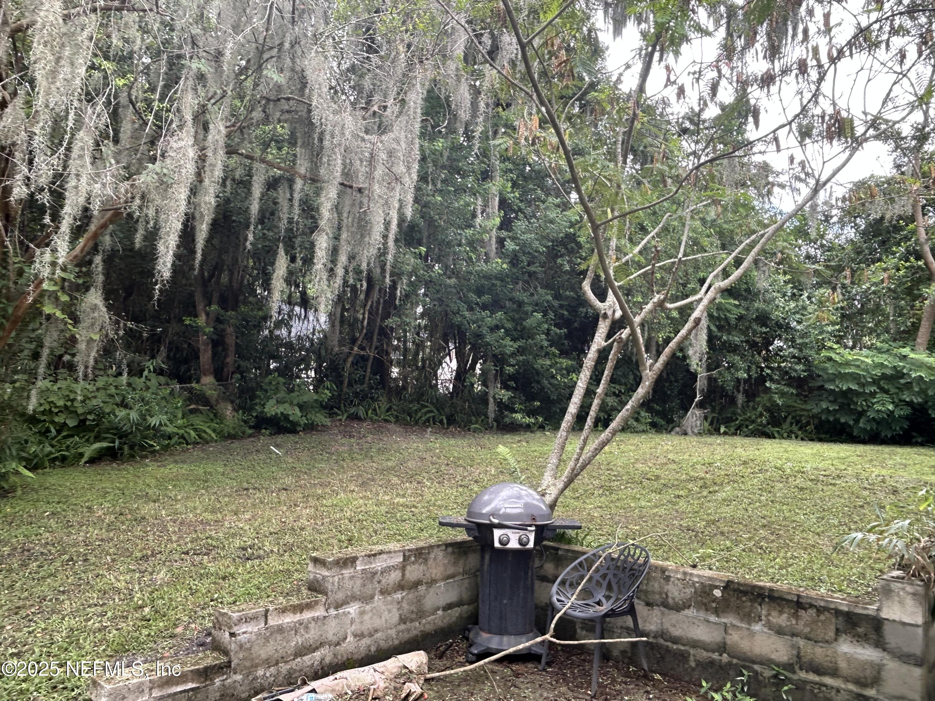 3173 St Augustine Road Jacksonville, FL 32207 - Photo 15 of 19 a backyard of a house with table and chairs