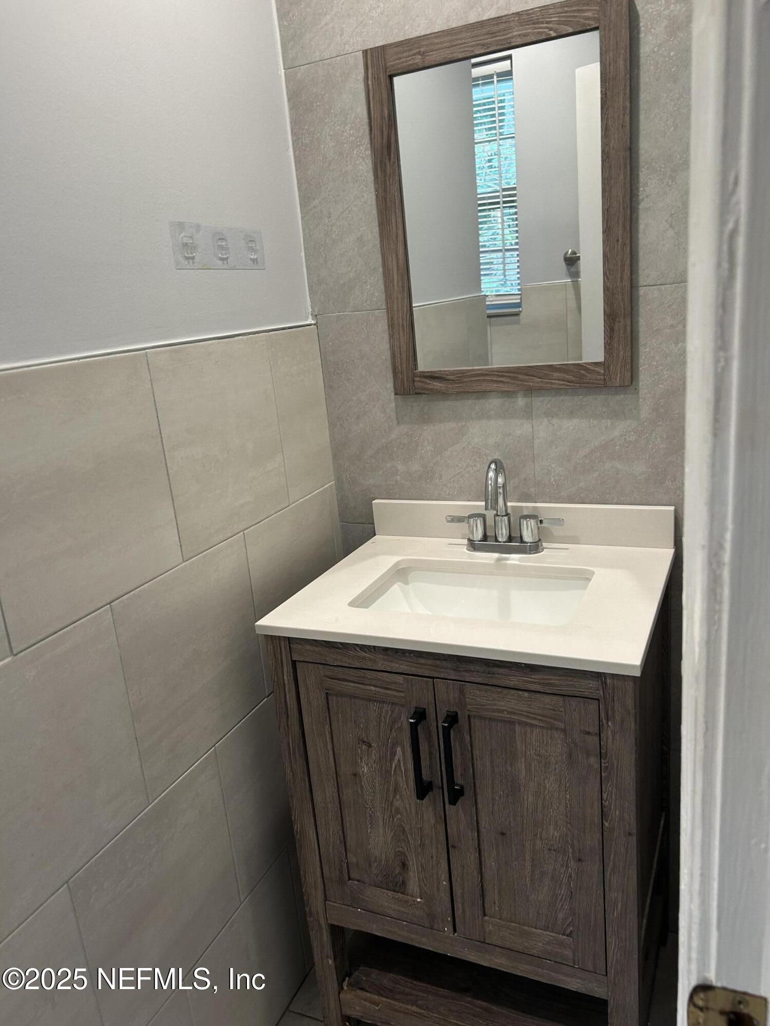 3173 St Augustine Road Jacksonville, FL 32207 - Photo 6 of 19 a bathroom with a sink and a mirror