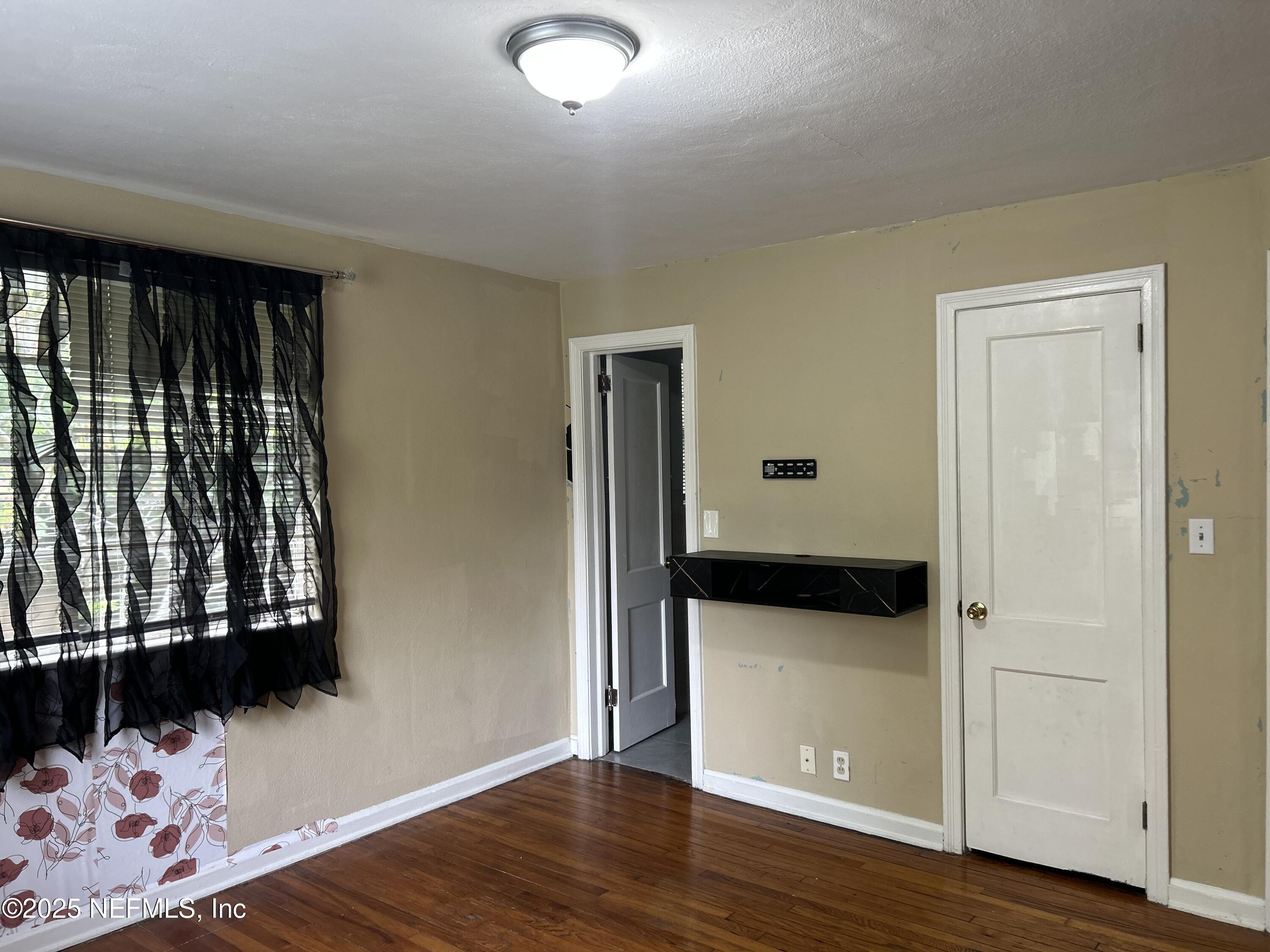 3173 St Augustine Road Jacksonville, FL 32207 - Photo 8 of 19 a view of a room with wooden floor and windows