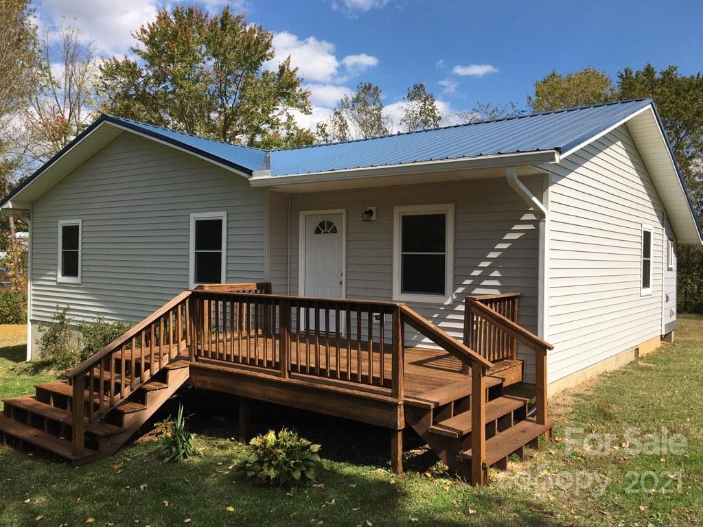 58 Ross Farm Road Waynesville, NC 28786 - Photo 1 of 29 a view of a house with a yard deck and a patio