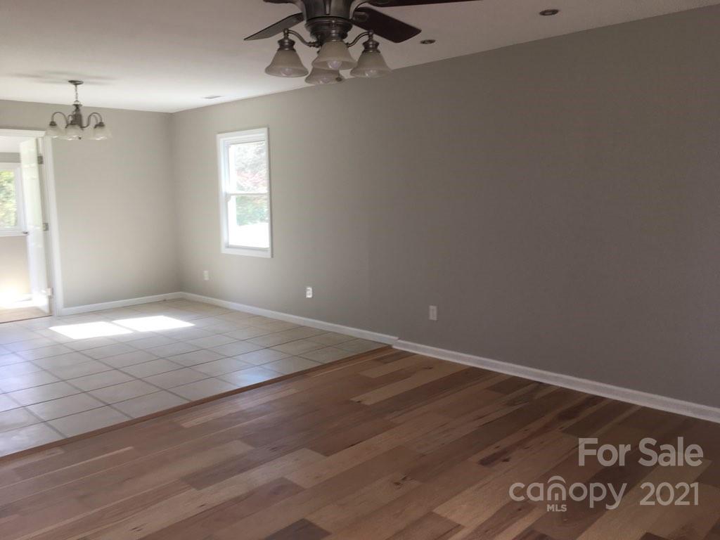 58 Ross Farm Road Waynesville, NC 28786 - Photo 16 of 29 en empty room with windows and ceiling fan