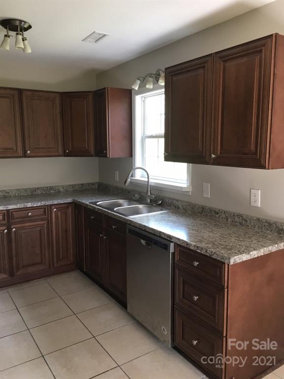 58 Ross Farm Road Waynesville, NC 28786 - Photo 19 of 29 a kitchen with granite countertop a sink and cabinets